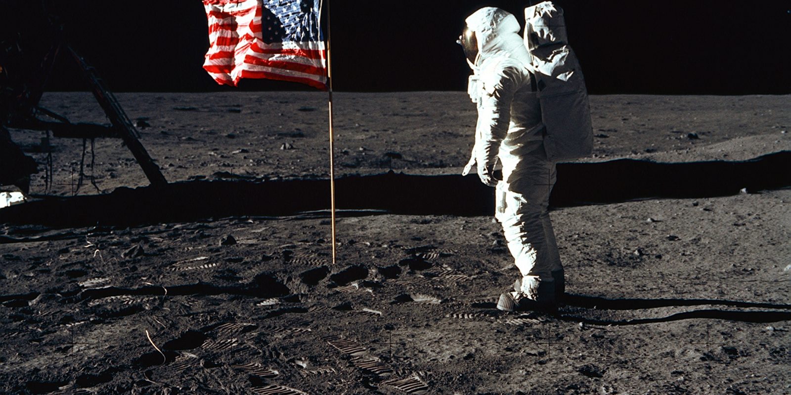 376713 03: (FILE PHOTO) Astronaut Edwin E. Aldrin, Jr., the lunar module pilot of the first lunar landing mission, stands next to a United States flag July 20, 1969 during an Apollo 11 Extravehicular Activity (EVA) on the surface of the Moon. The 30th anniversary of Apollo's moon landing is celebrated July 20, 1999. (Photo by NASA/Newsmakers)