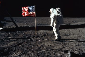 376713 03: (FILE PHOTO) Astronaut Edwin E. Aldrin, Jr., the lunar module pilot of the first lunar landing mission, stands next to a United States flag July 20, 1969 during an Apollo 11 Extravehicular Activity (EVA) on the surface of the Moon. The 30th anniversary of Apollo's moon landing is celebrated July 20, 1999. (Photo by NASA/Newsmakers)