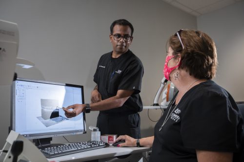 Dr. Sai Chavala, a retina specialist and professor of surgery at the TCU and UNTHSC School of Medicine in Fort Worth, goes over a retinal scan with Tori Paugh, a certified ophthalmologist assistant, Wednesday July 22, 2020. Photo by Rodger Mallison