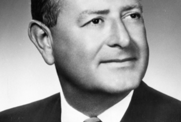 A black and white headshot of Louis Barnett