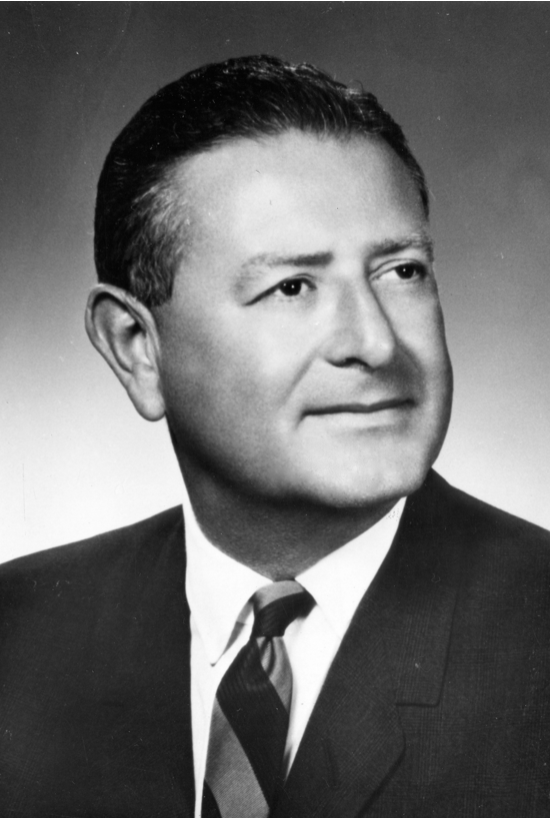 A black and white headshot of Louis Barnett