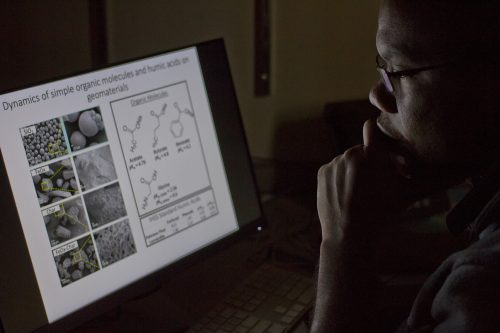 Omar Harvey looks at data on a computer