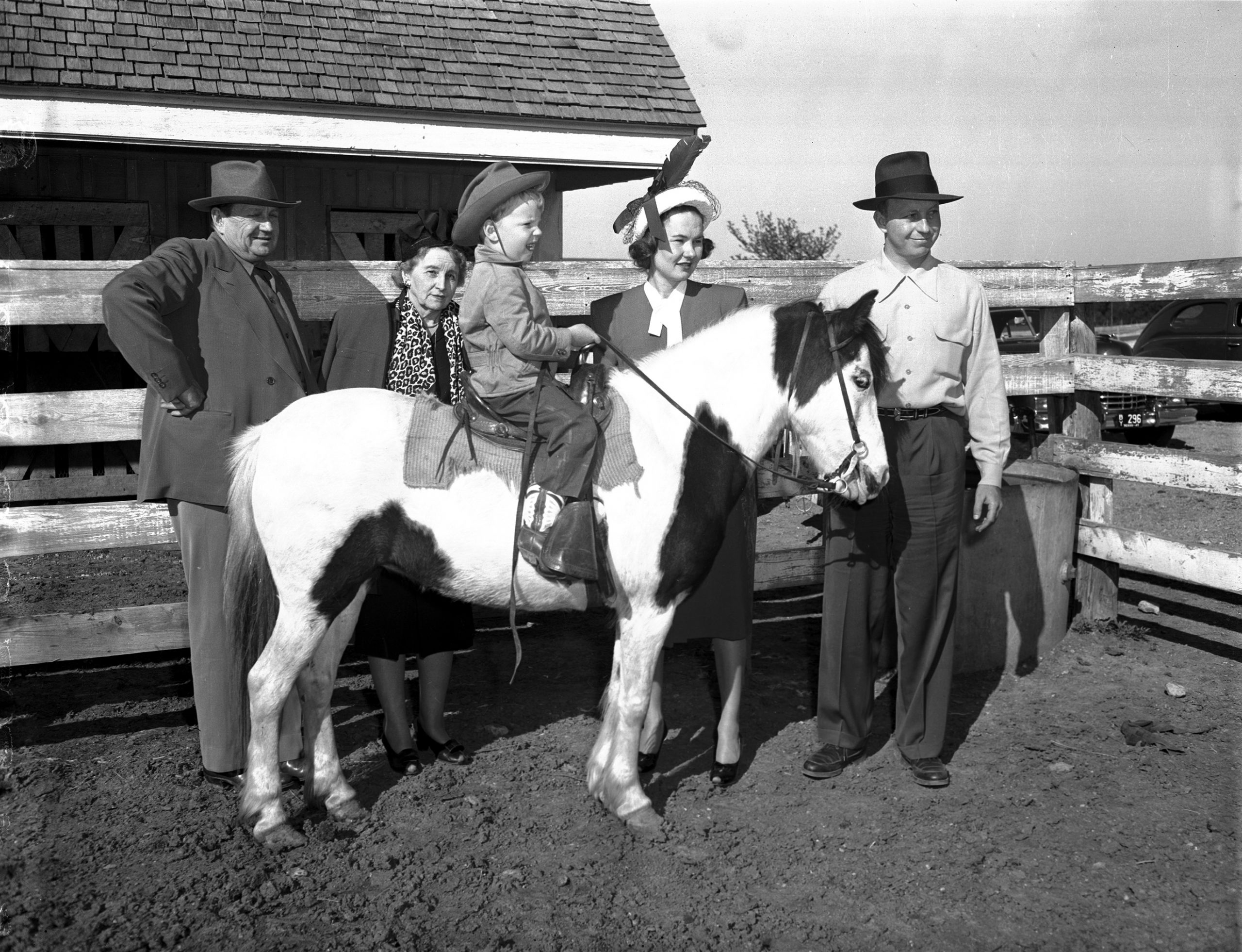 Sid Richardson (left) with great nephew Edward Perry Bass who is sitting on a paint pony; his father Perry Bass (right) and mother Nancy Lee Bass and Annie Richardson Bass (Sid's sister, Perry's mother, and Edward's grandmother), Dutch Branch Ranch, Benbrook, 1947