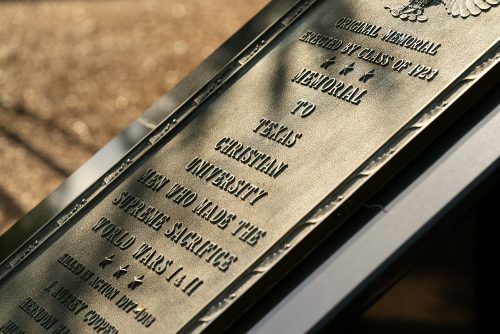 A close up of a TCU Veterans Plaza dedication plaque