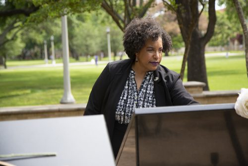 TCU's Director of Veterans Services April Brown visits Veterans Plaza on the TCU campus. Brown coedited the book Voices of America: Veterans and Military Families Tell Their Own Stories with author Ethan Casey. It contains a range of narratives from TCU faculty, staff, students and alumni and was published by TCU Press in November 2020. Photo by Joyce Marshall, April 26, 2021