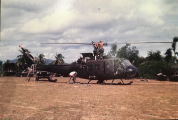 6 U.S. Army soldiers repair the blades of a Huey helicopter in South Vietnam. None of the men are Jerry or Bruce. (Courtesy of Bruce Holmberg)