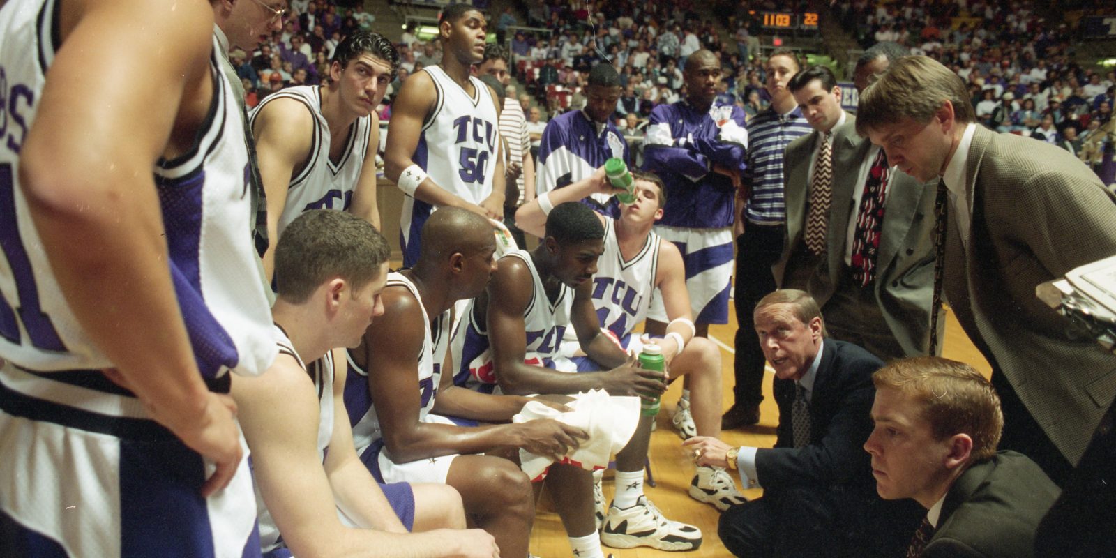 TCU basketball takes a time-out on the basketball court sideline to listen to coach Billy Tubbs.
