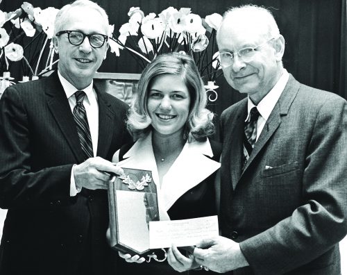 Valerie Neal, winner of the chapter’s first Phi Beta Kappa Award, receives a plaque and a check at Honors Convocation from James Newcomer, left, vice chancellor of academic affairs, and Malcolm McLean, president of the TCU chapter of Phi Beta Kappa. Courtesy of TCU Special Collections