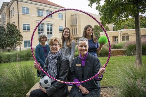(L-R) Ann Johnson, Sharon Canclini, Caitlin Dodd, Dr. Pam Frable and Dr. Danielle Walker and other members of the Harris College of Nursing and Health Sciences faculty have launched an initiative to foster an awareness and culture of wellness among the nursing students. Managing stress with play and meditation is part of that initiative. They appear here in the garden area outside the Anne Richardson Bass Building. Photo by Rodger Mallison, October 29, 2020