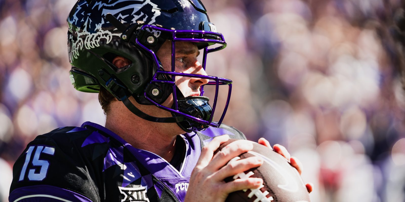 TCU quarterback Max Duggan in a purple helmet with a silver horned frog