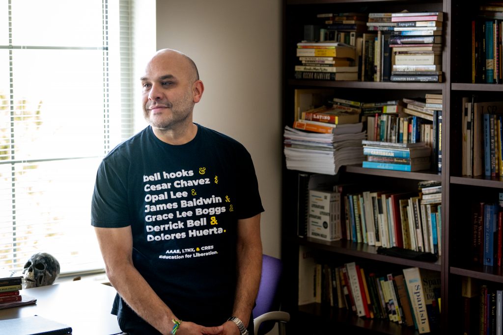 David Colón, professor of English and director of graduate studies in TCU's AddRan College of Liberal Arts, stands in his office, March 6, 2024. Colón was part of a team that rewrote the Latinx Studies curriculum for Fort Worth ISD. Photo by Leo Wesson.