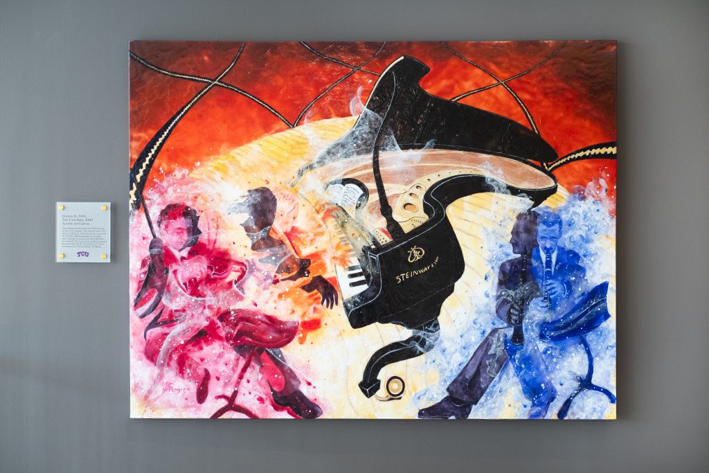 A photo of Donray's 2009 painting "Trio Con Brio," illustrating three TCU music professors — violist Misha Galaganov, pianist John Owings and clarinetist Gary Whitman — each rendered in a different vibrant color. 