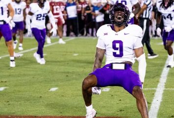 Photo of Marcel Brooks celebrating on the field of Stanford Stadium during TCU Football's 2024 season opener against the Cardinal. Brooks wears a purple TCU football helmet and white jersey, purple football pants and white cleats.