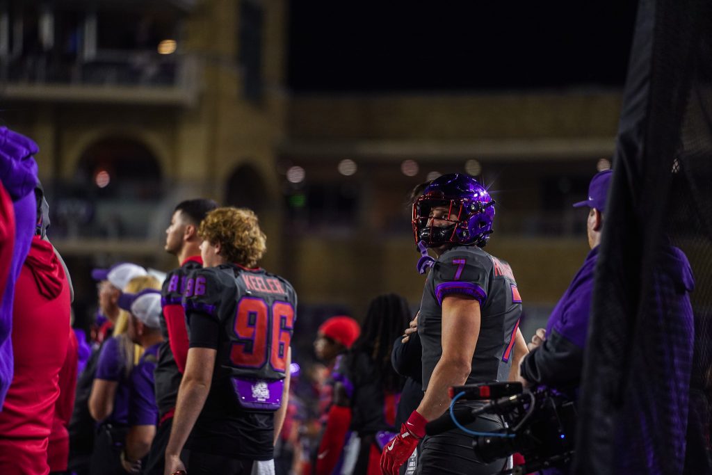 TCU football player JP Richardson and teammates on the sidelines at Amon G. Carter Stadium during a November 2024 Big 12 game against Oklahoma State.