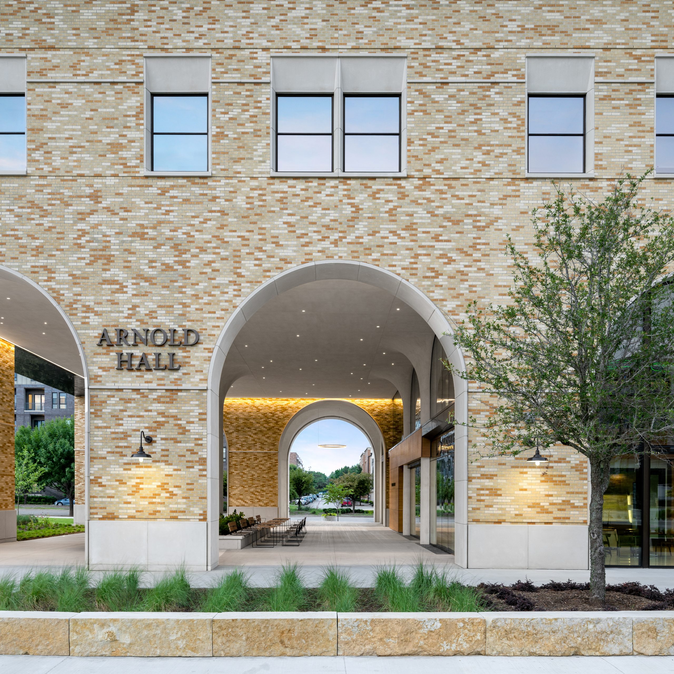 Photograph of Arnold Hall's two-story portico on the east side of the Burnett School of Medicine, taken at dusk or dawn.