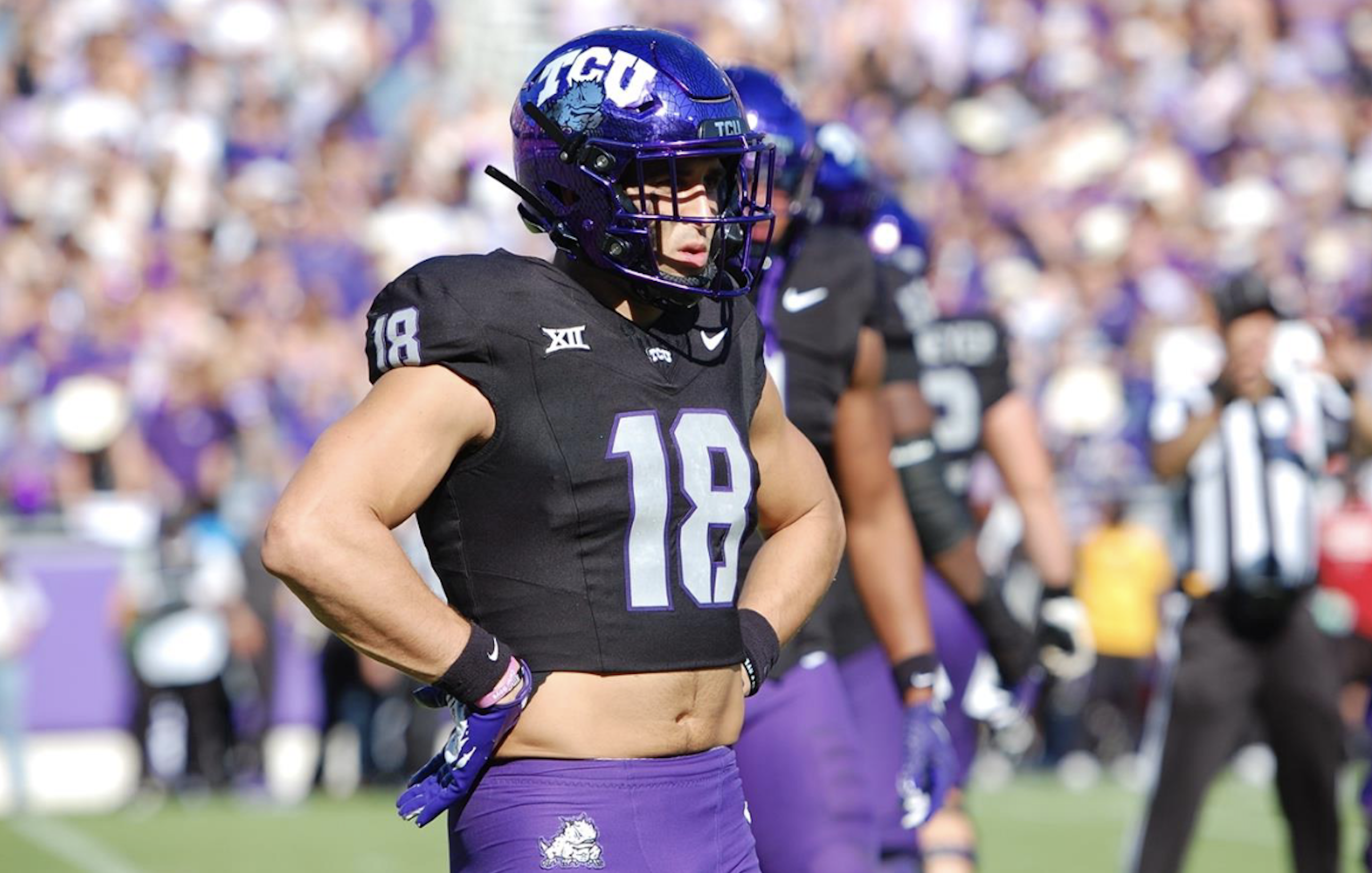 TCU football player Jack Bech stands on Moncrief Field at Amon G. Carter Stadium in Fort Worth, Texas, during a 2024 NCAA football game. Bech is wearing a purple TCU football helmet, a black jersey with silver-gray numbering and purple pants.