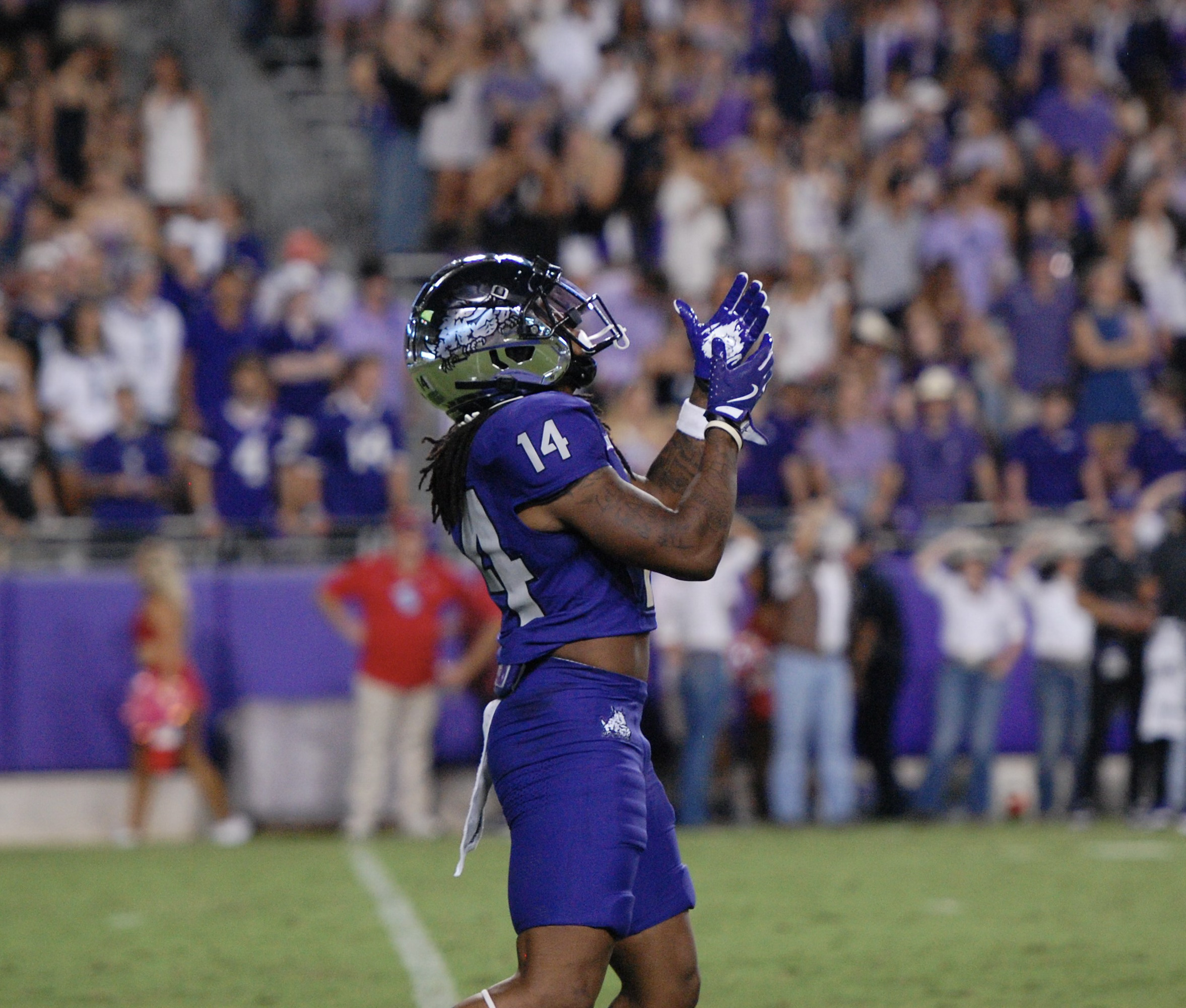 Profile photo of TCU student-athlete Jordyn Bailey preparing to catch a kickoff during a 2024 TCU football game at Amon G. Carter Stadium in Fort Worth, Texas. Bailey is wearing a chrome silver helmet, and purple jersey, pants and gloves.