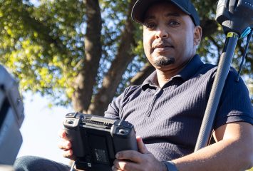 Esayas Gebremichael poses on the TCU campus with some of the equipment he uses in his research.