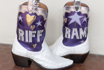 Pair of purple and white cowboy boots with silver detailing; one boot reads 'Riff' and the other 'Ram.'