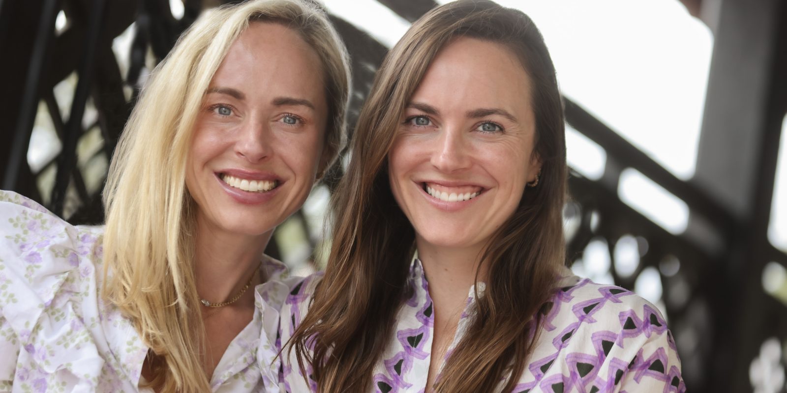 Lizzie Means Duplantis (left) and Sarah Means, founders of Miron Crosby, pose against a bright background.