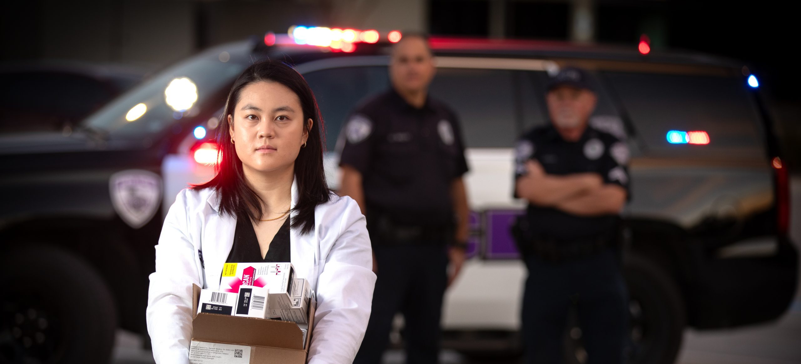 Angel Sheu holding naloxone boxes — TCU Magazine