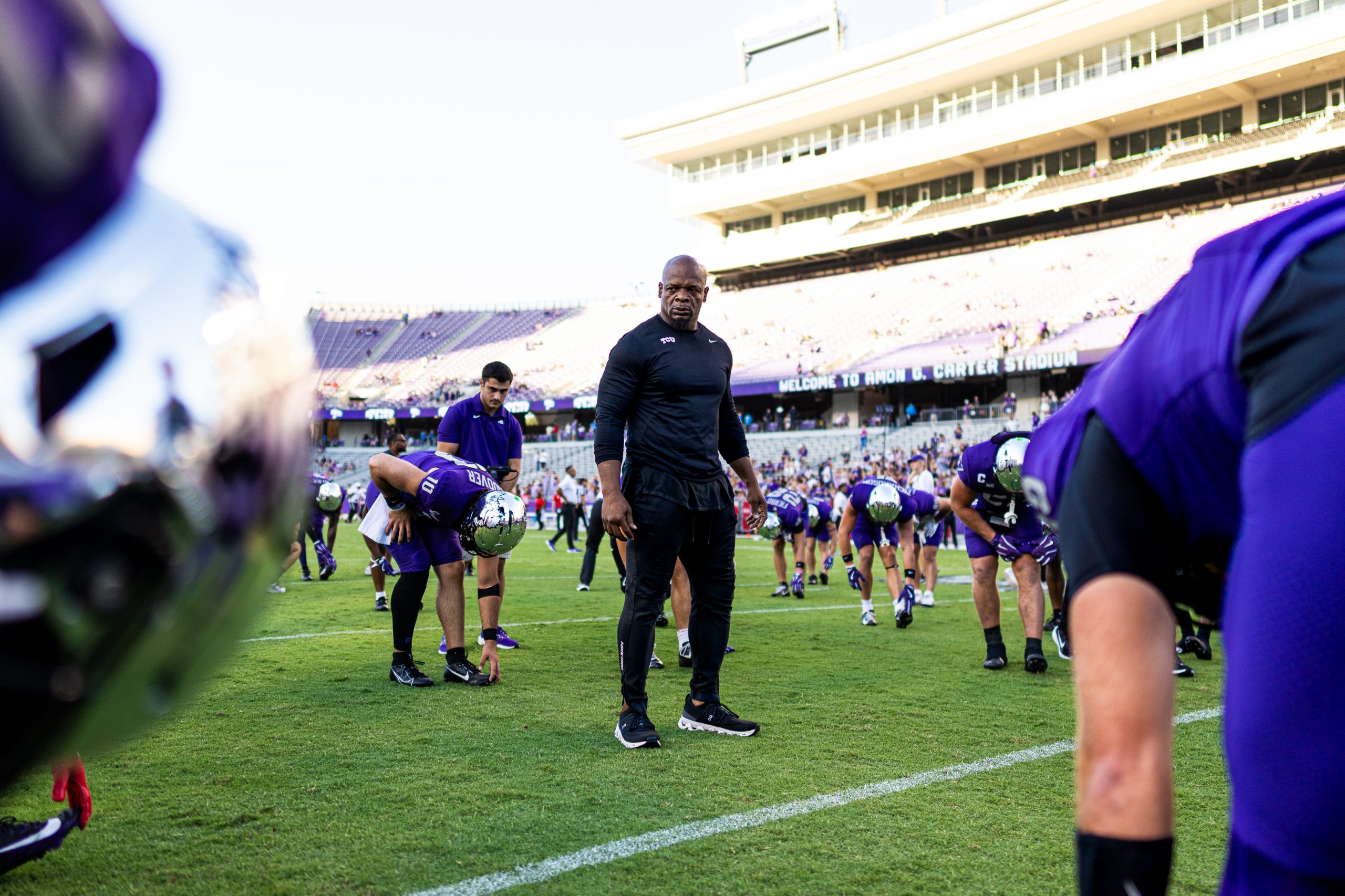 Kaz Kazadi stands on the field, monitoring warmups before an October 2024 game against Houston.