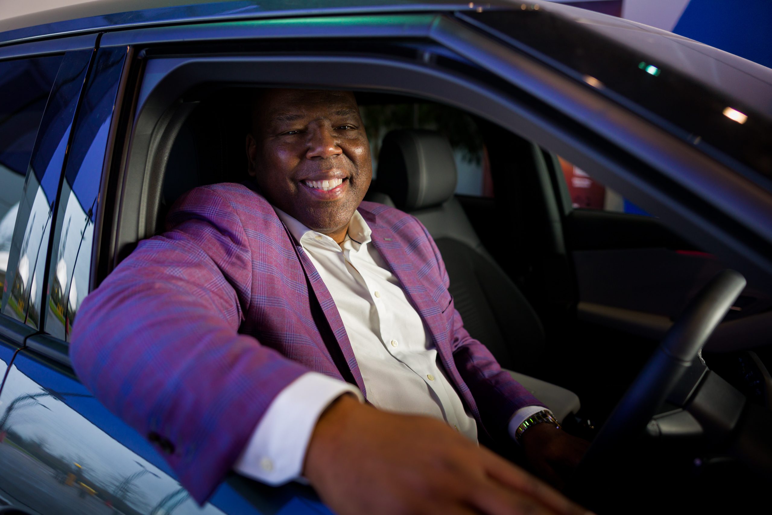 Photograph of Ford Credit Europe Chief Executive Officer Carlos Treadway seated in the driver’s seat of a car, smiling toward the camera.