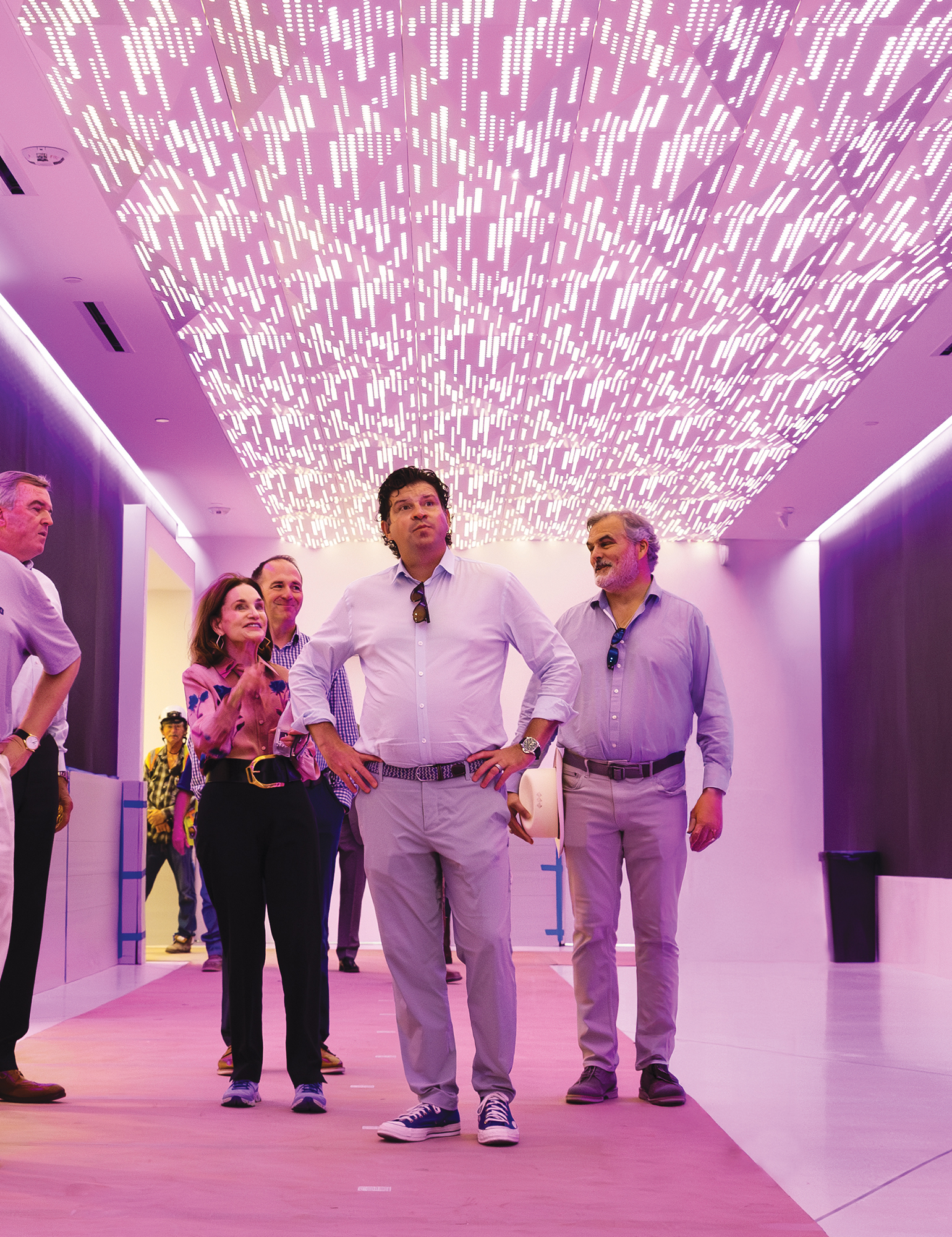 Photograph of TCU Chancellor Daniel W. Pullin with several university leaders, touring an entryway to the new TCU Athletics Human Performance Center.