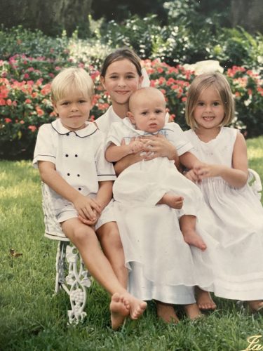 Early 2000s photograph of the Bech siblings wearing white clothing. From left are Tiger, Ginnie, Jack and Sophie.