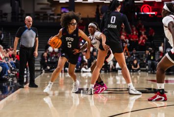 TCU’s Olivia Miles dribbles during an NCAA basketball game against Cincinnati, with teammate Kennedy Basham setting a screen on a Bearcats defender.