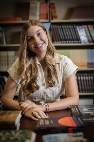 Former Boller Review editor Alexandra "Lexie" Woodall sits at a table in the offices of TCU Press