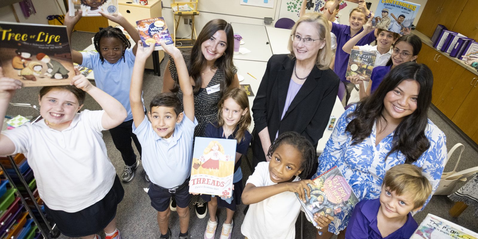 Jan Lacina poses with a group of children from the Starpoint Critical Literacy Book Club