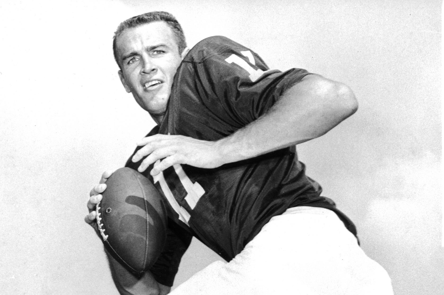 TCU quarterback Sonny Gibbs, in uniform without a helmet, winds up to throw in an early 1960s promotional photo.