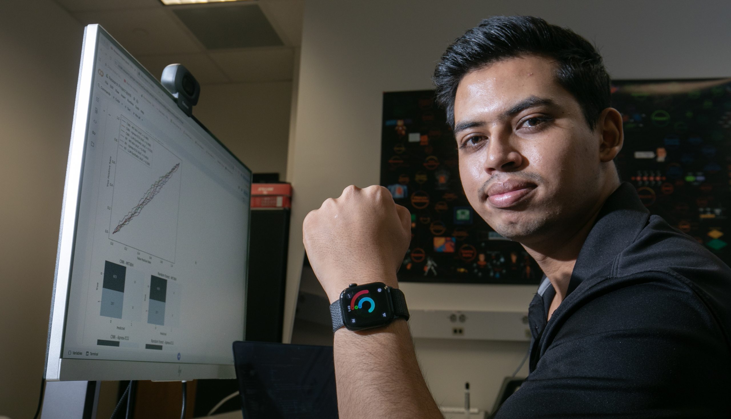 Computer science major Sujit Bhandari wearing a wearable device while working to create an AI diagnostic model for health monitoring.