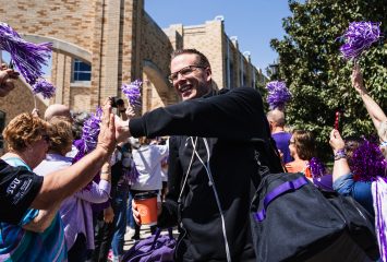 TCU women's basketball head coach Mark Campbell high-fives fans during the team's send-off to Sacramento ahead of the Sweet 16.