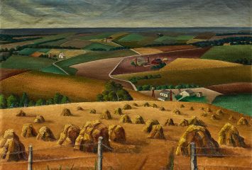 A 1937 painting by American artist Florence E. McClung titled “Squaw Creek Valley,” depicting a sweeping rural landscape. In the foreground, golden wheat shocks (bundled sheaves) are arranged in rows across a harvested field, framed by a barbed wire fence with weathered wooden posts. The middle ground shows a patchwork of cultivated fields in greens, browns, and ochres, with small farmsteads — white houses with red barns and windmills — nestled among winding pale roads. The composition recedes into rolling hills with more fields and scattered trees, leading to a hazy blue-gray horizon under a cloudy sky. The style is characteristic of American Regionalist painting from the 1930s, with stylized, slightly flattened forms and a strong sense of agricultural rhythm and pattern.