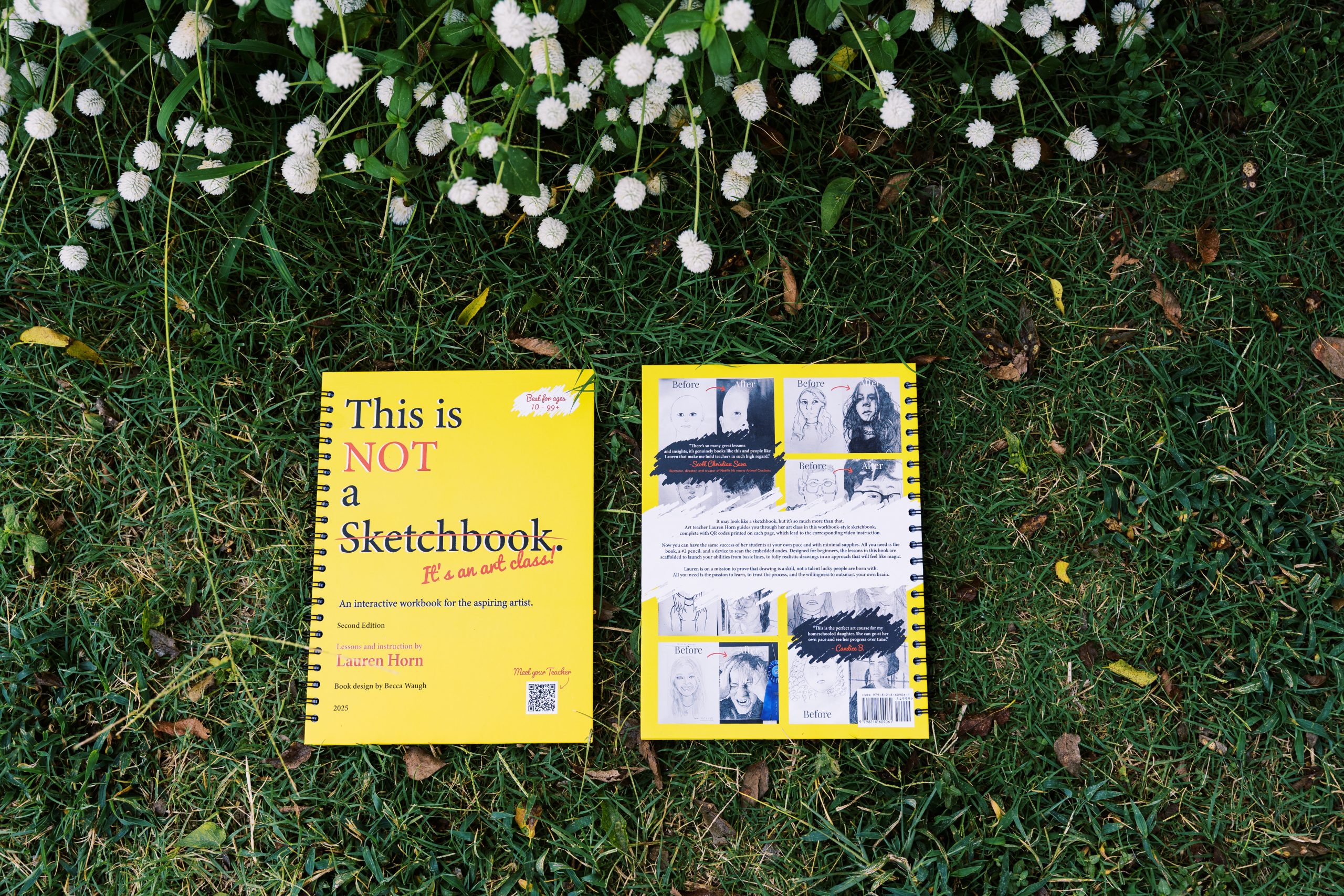 A yellow spiral-bound workbook titled “This is NOT a Sketchbook” lies open-faced on grass beside its back cover, which shows a grid of before-and-after student drawings.