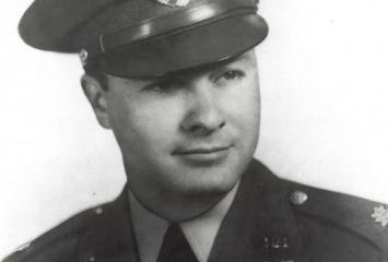 Black-and-white portrait of Maj. Horace S. Carswell Jr. in a military uniform and peaked officer's cap with an insignia. Pilot wings are pinned to his chest.