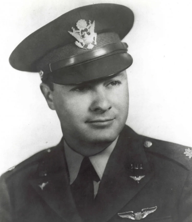 Black-and-white portrait of Maj. Horace S. Carswell Jr. in a military uniform and peaked officer's cap with an insignia. Pilot wings are pinned to his chest.