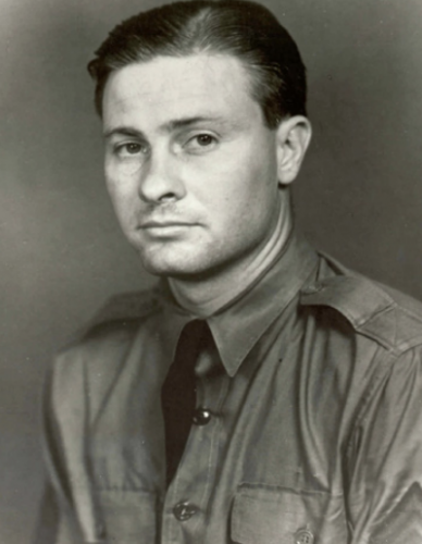 Black-and-white portrait of Horace S. Carswell Jr. in a collared shirt with shoulder straps and a dark tie.